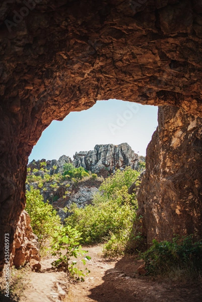 Obraz Beautiful shot of mountains from inside a cave. It is full of vegetation. (Cerro del Hierro, Spain)