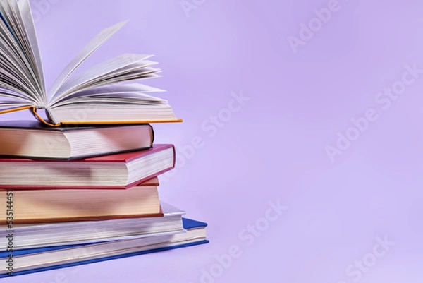 Fototapeta Close-up of a stack of books with one open book on top