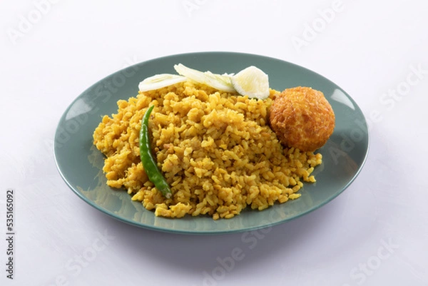 Fototapeta Bengali dish khichdi or khichuri made from a combination of lentils and rice along with Indian spices. in a mud bowl isolated on white background Bengali dish khichdi or khichuri.
