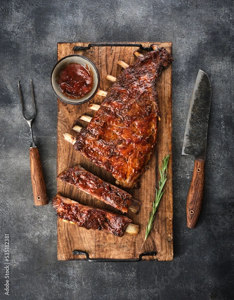 Fototapeta Delicious smoked pork ribs glazed in BBQ sauce.