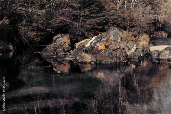 Obraz Close-up of a pair of old and big rocks in the middle of a small river placed in Cordoba province Argentina.