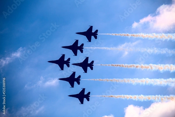 Fototapeta Fighter jets in formation flying past clouds