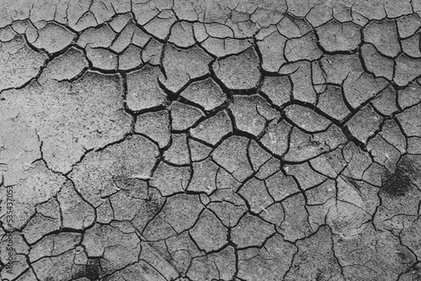 Fototapeta Waiting for monsoon to arrive. Cracks in dry earth due to lack of rain. Dry season in northern part of Sri Lanka.