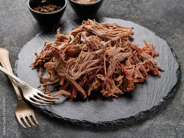 Obraz Traditional barbecue pulled pork. Slow cooked pulled pork shoulder. Juicy pork meat cooked in a smoker by low and slow