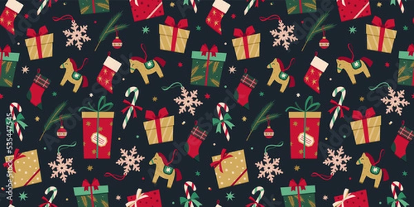 Fototapeta Vector seamless pattern with Christmas decoration in flat style. New Year stylish background of Christmas gift boxes, presents, socks, toys, candy cane, snowflake, fur tree branch, stars and confetti.