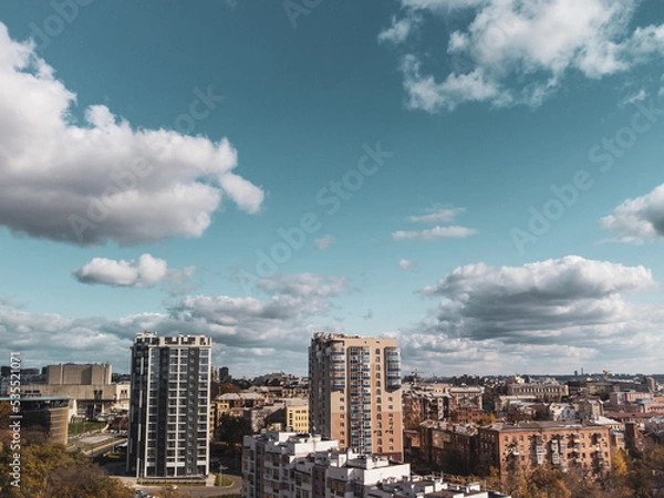 Fototapeta City aerial view, residential buildings in autumn with scenic cloudy blue sky, sunny downtown. Kharkiv, Ukraine