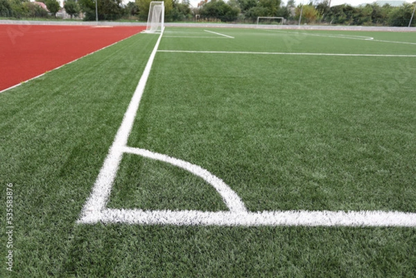 Obraz corner of a football artificial field with white markings in the stadium