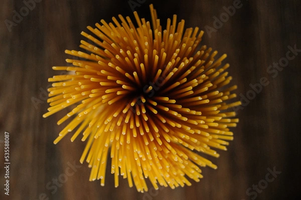 Obraz 
Spaghetti on wooden background top view