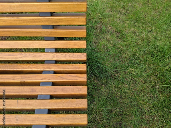 Fototapeta Wooden empty bench in the park