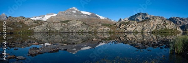 Fototapeta when the highest peak of the Vanoise massif, the Dent Parrachee, is reflected in the waters of Lac Blanc