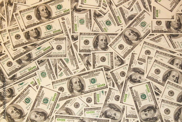 Fototapeta Many hundred dollar bills on the table. One hundred US dollar bills background. U.S. dollars. Banking and finance signs. Much money background. Top view. Close-up