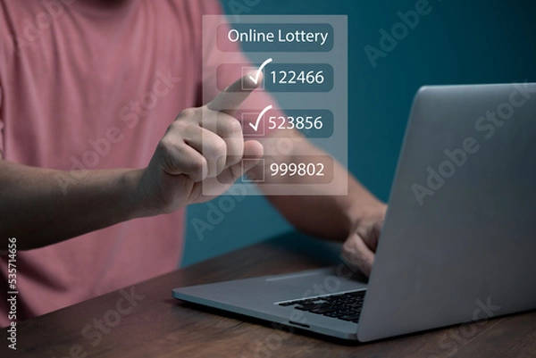 Obraz Man using computer and touching on virtual Online lottery screen to buy two number set. 