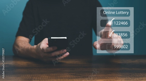 Fototapeta Man using smartphone and touching on virtual Online lottery screen to buy two number set. 