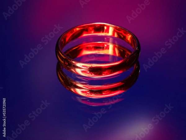 Obraz Rings with fire reflection on blue background	