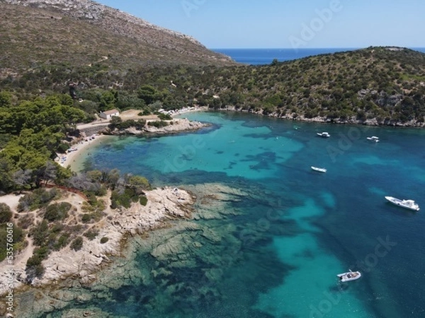 Fototapeta Aerial view of Cala Moresca and Figarolo Island in Golfo Aranci, north Sardinia. Birds eye from above of yacht, boats, crystalline and turquoise water. Tavolara Island in the background, Sardegna.
