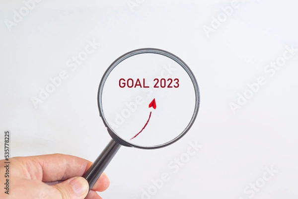 Fototapeta Paper airplane flying to 2023 hefe in magnifying glass. business creativity new idea discovery innovation technology. new year new goal idea concept.