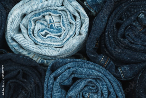 Fototapeta Large quantity of rolled up jeans in lots of shade of blue