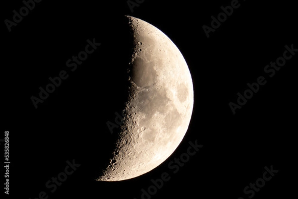 Fototapeta Moon in First Quarter Phase viewing detail of the craters during the night.