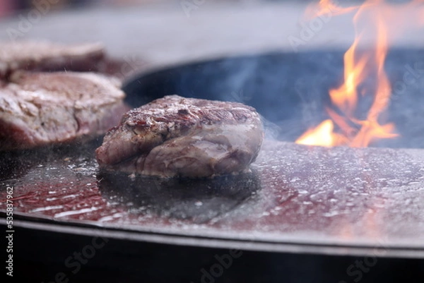 Obraz Steak with smoke and flame while preparing