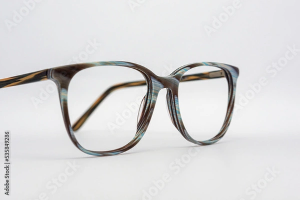 Obraz Eyeglass frames, lenses, various colors, both metal and plastic, on a beautiful colored background.