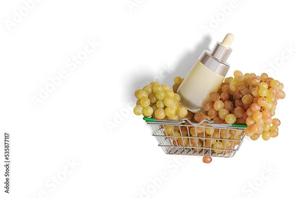 Fototapeta Empty cosmetic package, bottle with bunches of grapes in a shopping cart. The concept of natural cosmetics.