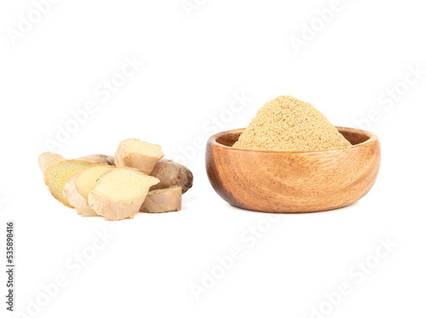 Fototapeta Ground ginger in a bowl and fresh ginger root on a white background.
