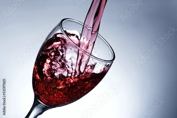 Fototapeta image pouring red wine into a glass