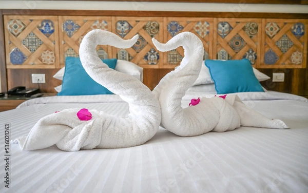 Fototapeta Two swans made of towels forming a heart.