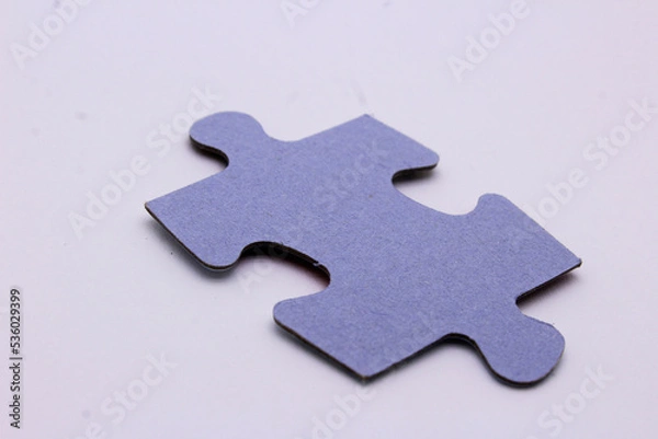 Fototapeta a piece of a puzzle on a white puzzle background
