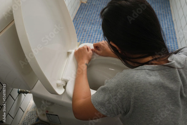 Fototapeta Woman drunk and vomit in bathroom
