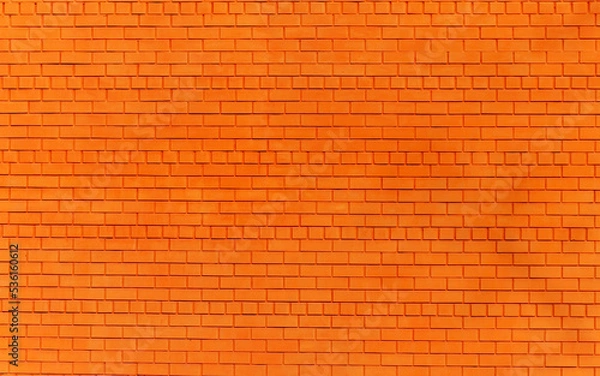 Fototapeta a brick wall painted orange as a background or texture