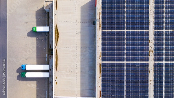 Fototapeta Industry with low carbon footprint. Industrial warehouses with solar panels on the roof. Technology park and factories  from above.