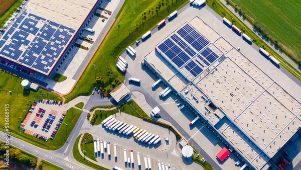 Fototapeta Industry with low carbon footprint. Industrial warehouses with solar panels on the roof. Technology park and factories  from above.