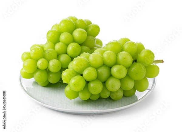 Fototapeta Shine Muscat with water droplets placed on a plate against a white background.