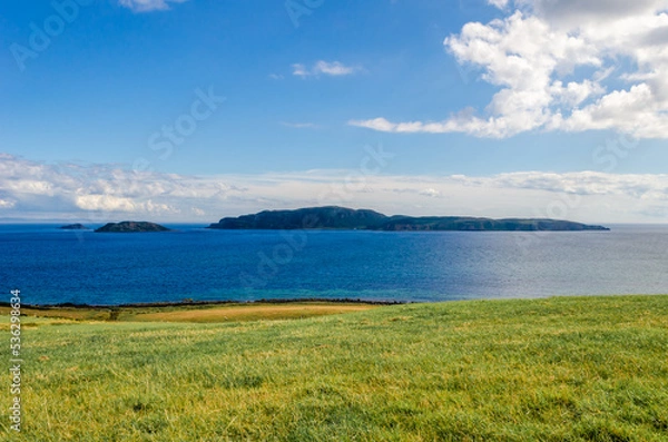 Fototapeta Sheep Island and Sanda Island on a Summer day from Southend near the Mull of Kintyre Argyll Scotland with copy space