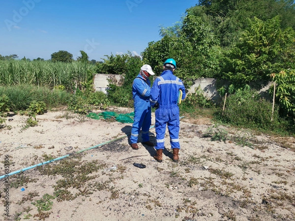 Fototapeta A radiation safety officer (RSO) inspecting radiation dose rate in a farming area around a drilling site