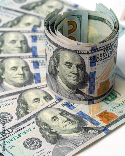 Fototapeta Money, US dollar bills background. Paper money is scattered on the table with silver coins. Photo for finance and economics concepts.