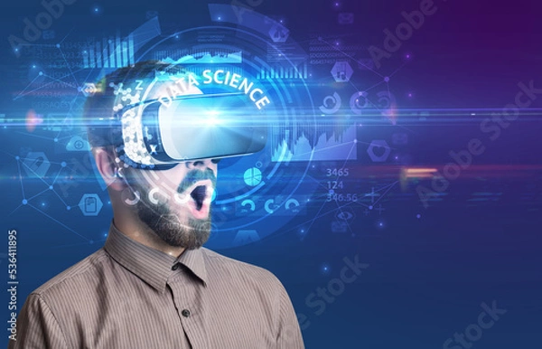 Fototapeta Businessman looking through VR glasses