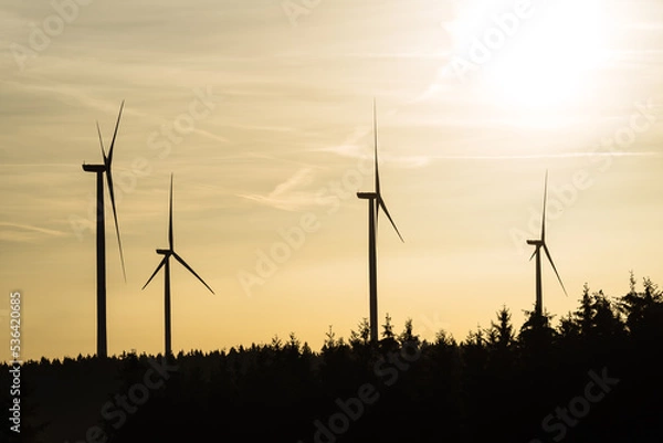 Fototapeta Wind turbine in the sunrise seen from an aerial view