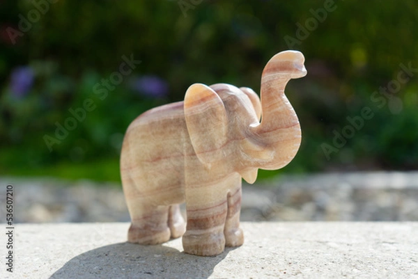 Obraz Elephant statue near house in front of garden.