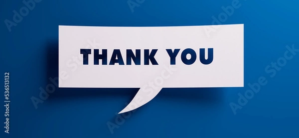 Fototapeta Speech bubble with the words thank you in front of a blue colored wall - 3D illustration