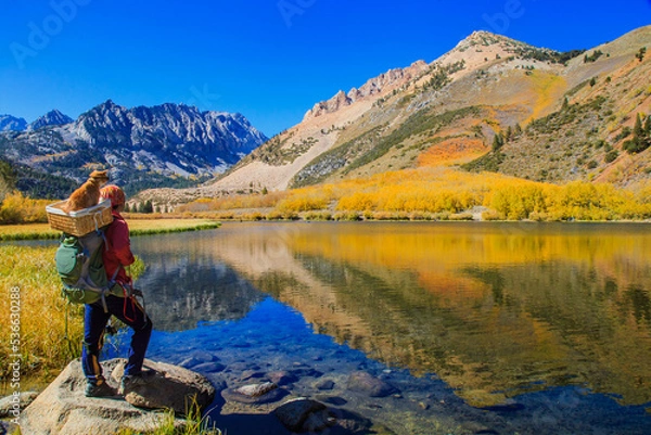 Obraz A backpacker enjoying  fall colors reflection of North Lake near Bishop in Eastern Sierra, California