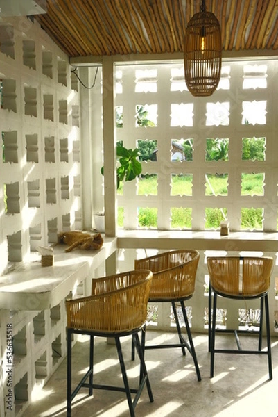 Obraz table and chairs and a cat