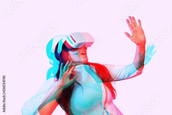Fototapeta Woman is using virtual reality headset. Image with double color exposure effect.
