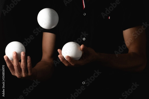 Fototapeta close up portrait of juggling balls, on black background