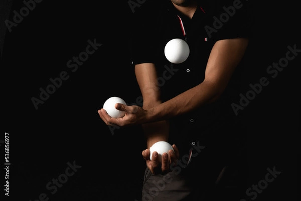 Fototapeta close up portrait of juggling balls, on black background