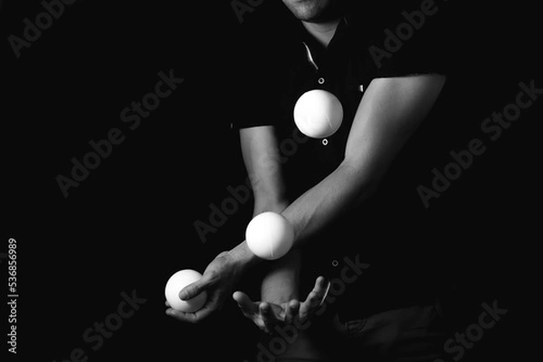 Fototapeta close up portrait of juggling balls, on black background