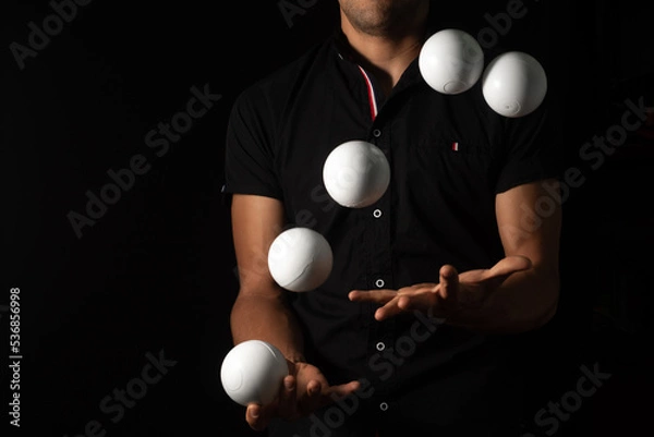 Fototapeta close up portrait of juggling balls, on black background