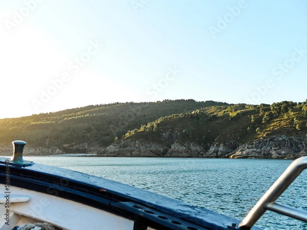 Fototapeta View to land from the ship at sea with sunset