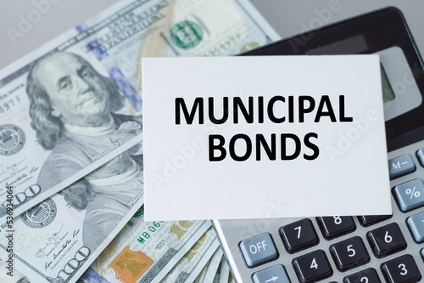 Fototapeta municipal bonds text on the card next to the calculator and money on the table